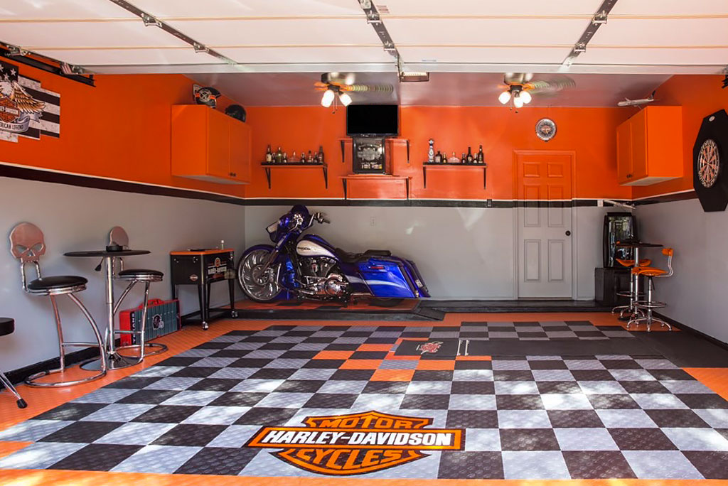 A garage with a custom bagger and Harley-Davidson garage floor tiles