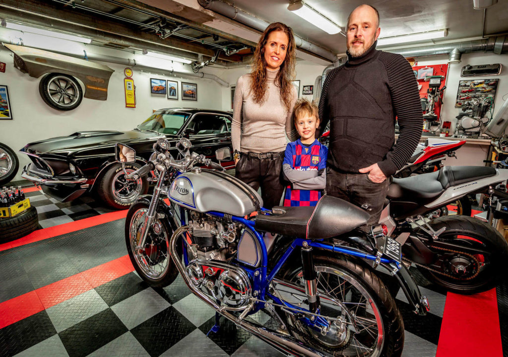 Guðmundur and Maríu with their son in their garage