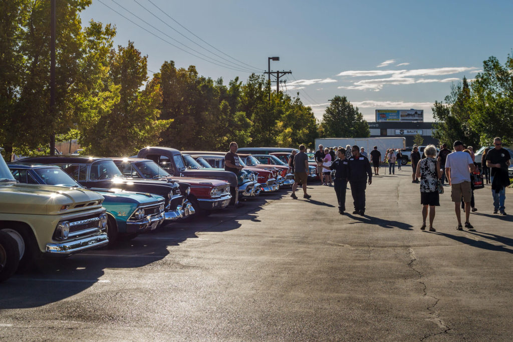 Members of the Hall of Fame Road Tour and RaceDeck crew discuss the cars and enjoy the event.