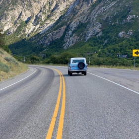A blue Bronco driving up Little Cottonwood Canyon in Salt Lake City Utah.