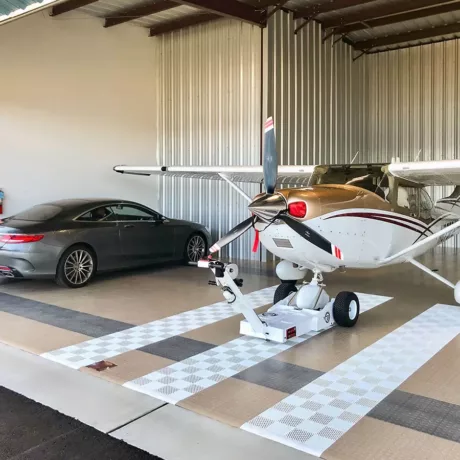 plane and mercedes in hangar